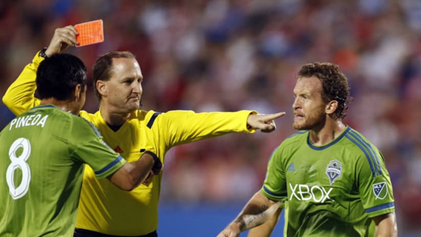 Red card shown to FC Dallas defender Kellyn Acosta as Chad Barrett and Gonzalo Pineda look on