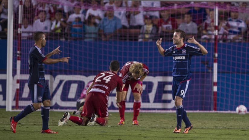 Mike Magee celebrates a goal while Matt Hedges and Stephen Keel try to regroups