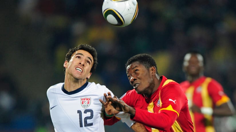 Jonathan Bornstein battles Asamoah Gyan in the Round of 16 match which eliminated the USA