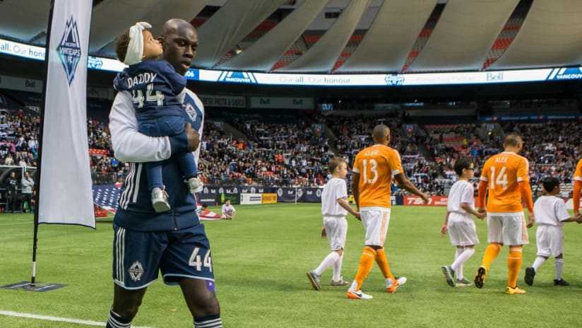 Pa-Modou Kah walks out with his daughter during his final MLS season