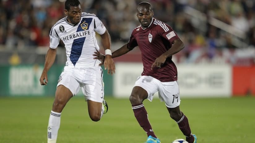 Omar Cummings of Colorado Rapids and David Junior Lopes of LA Galaxy battle for the ball