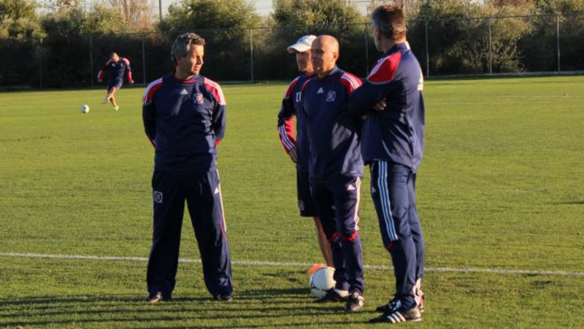Chicago Fire head Frank Klopas talks with the coaching staff during a preseason workout in California