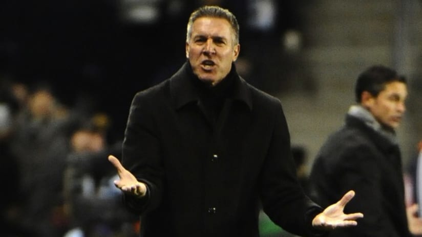 Peter Vermes gestures during a playoff game with New England