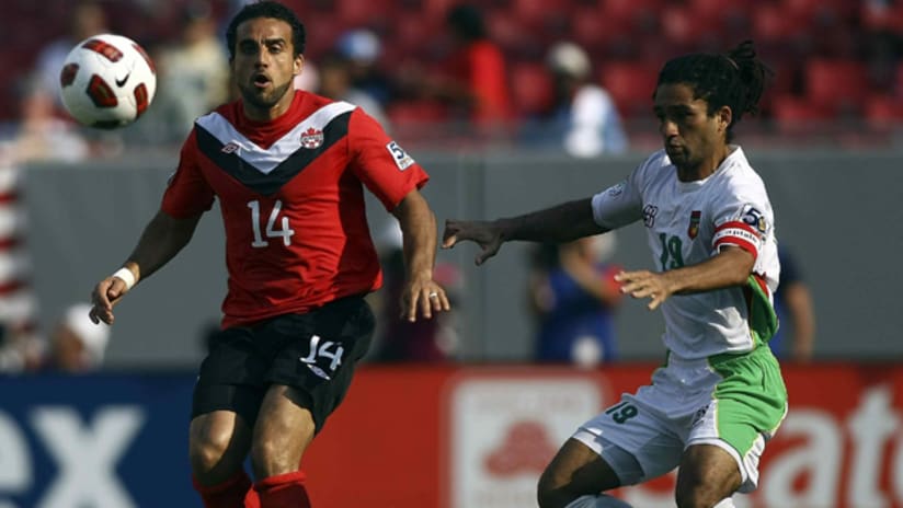 Gold Cup: Canada's Dwayne De Rosario faces a challenge from Guadeloupe's Stephane Auvray, June 11, 2011.