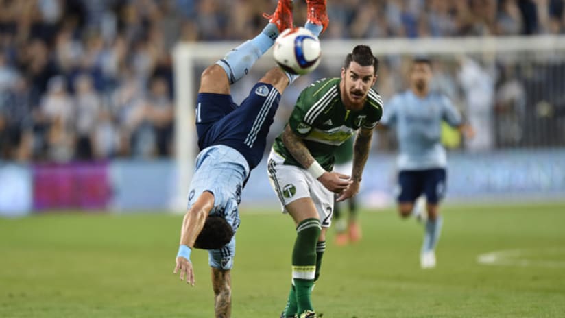 Liam Ridgewell of the Portland Timbers upends Dom Dwyer of Sporting Kansas City Sporting KC