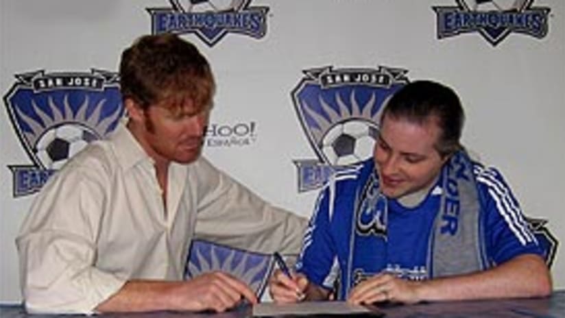 Joe Pate (right) signs the paperwork to become the Quakes' 'Player 29'.