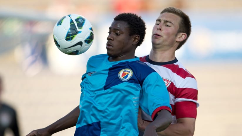 A US and Haitian player battle for the ball in the CONCACAF U-20 championship