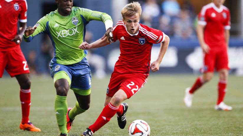 Tommy Thompson of the San Jose Earthquakes dribbles away from Jalil Anibaba