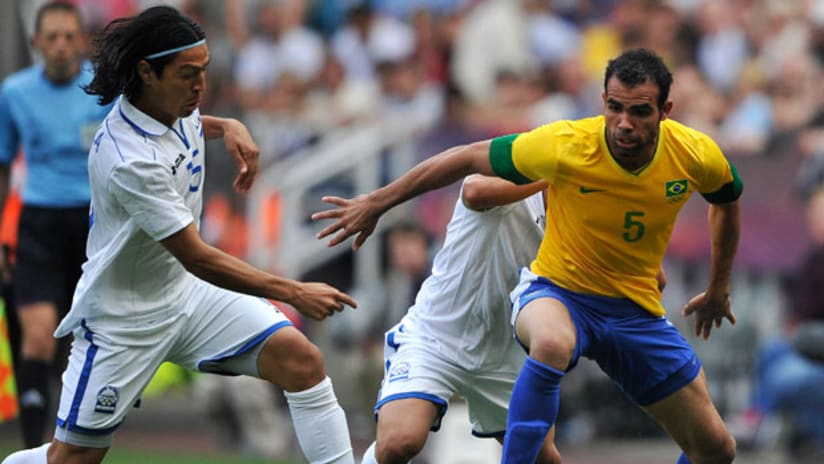 Roger Espinoza, Honduras, challenges Brazil's Sandro.