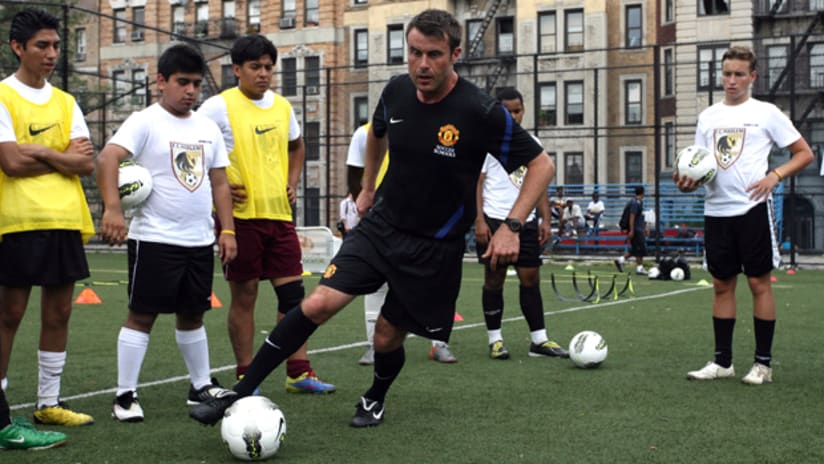 Manchester United Soccer Schools coach Dean Wilson coaches kids from FC Harlem at a clinic held at the Jacob Schiff Soccer Field in Harlem, NYC.