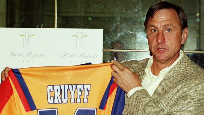 Johan Cruyff holds up his legendary No. 14 kit