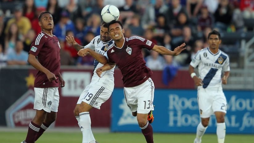 Juninho of LA Galaxy and Kamani Hill of Colorado Rapids battle for the ball