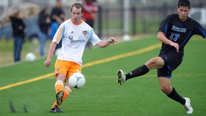 Dynamo rookie Brian Ownby delivers a cross during a scrimmage vs. HBU