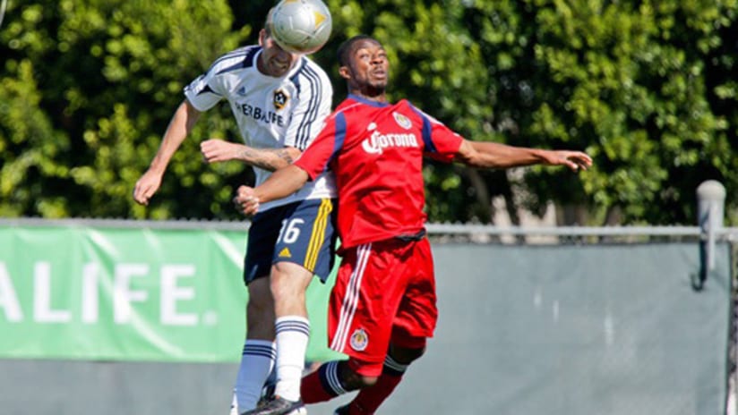 Chivas USA's Mike Lahoud challenges an LA defender for the ball
