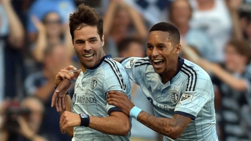 Sporting KC midfielder Benny Feilhaber is congratulated by defender Amadou Dia after scoring