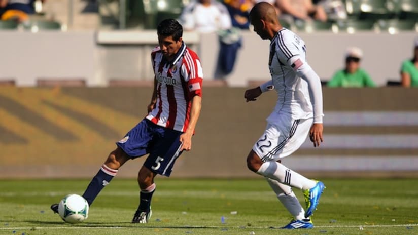 Chivas USA's Carlos Borja puts a cross past the LA Galaxy's Leonardo for equalizer
