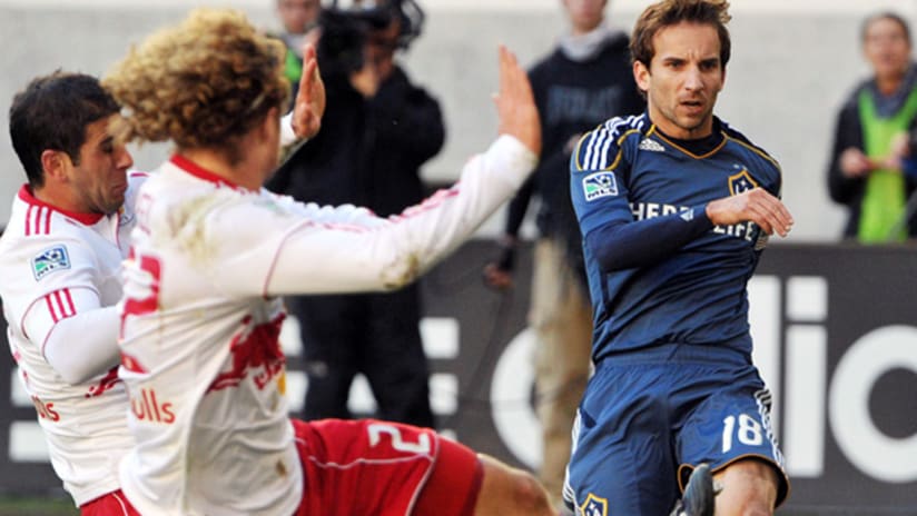 LA Galaxy's Mike Magee gets a shot off as New York's Carlos Mendes (far left) and Stephen Keel close in.
