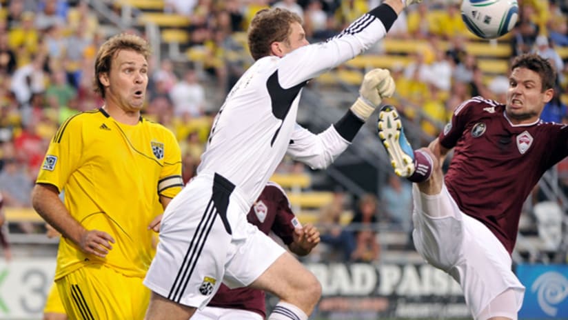 Crew's Chad Marshall (left) watches as teammate Will Hesmer punches a ball away from Colorado's Drew Moor.