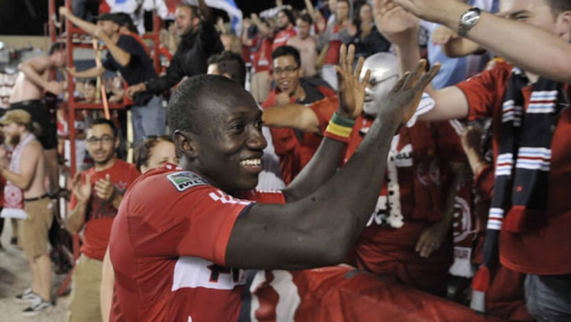 Dominic Oduro celebrates with Section 8