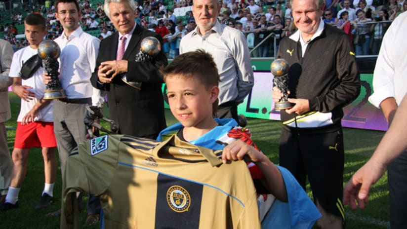 A youth holds up a Philadelphia Union jersey in Poland.