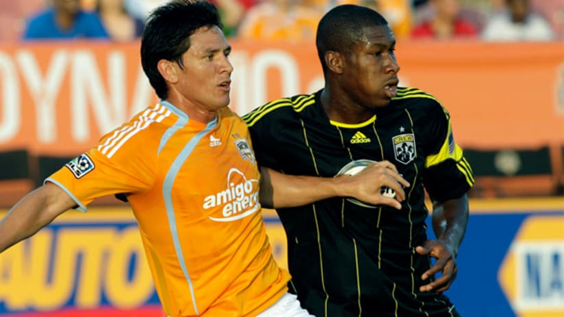 Columbus' Iro, wearing the Crew's uncharacteristic black kit, fights with Houston's Ching for the ball during a 0-0 draw.