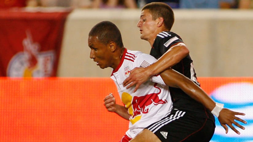 Juan Agudelo battles Perry Kitchen on Saturday night at Red Bull Arena.