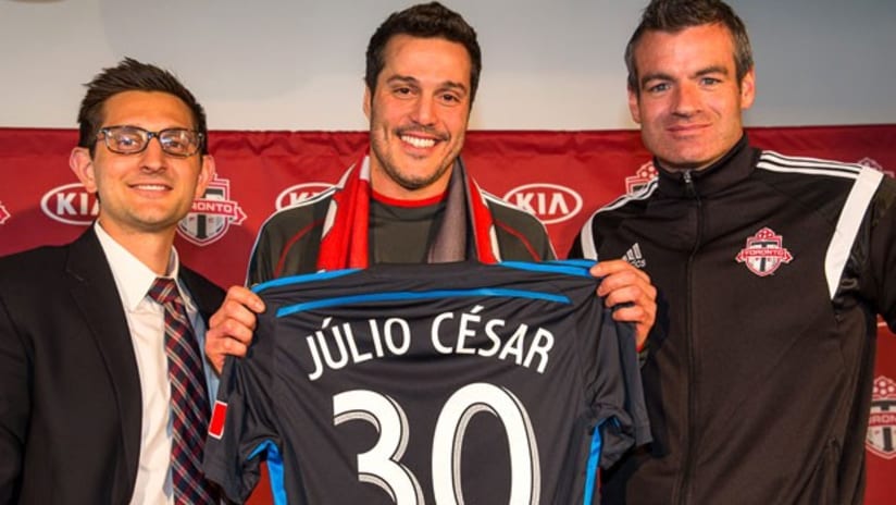 Julio Cesar is flanked by Toronto FC's Tim Bezbatchenko and Ryan Nelsen