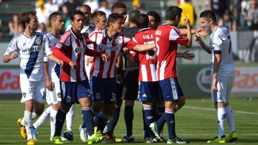 Chivas USA and LA Galaxy players come together after Robbie Keane gets a yellow card