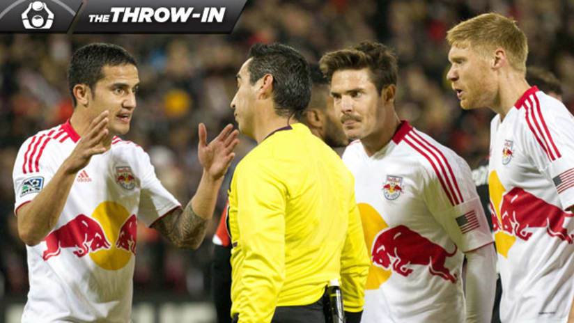 Throw-In Tim Cahill, Heath Pearce surround the ref