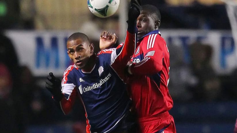 Revolution's Jerry Bengtson and Fire's Jalil Anibaba challenge for the ball.