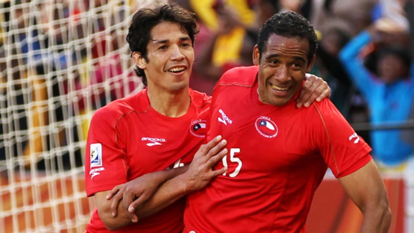 Jean Beaujesour celebrates with Matias Fernandez after scoring against Honduras in the Group H opener