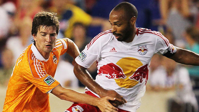 Bobby Boswell, Houston, battles with Thierry Henry, New York.