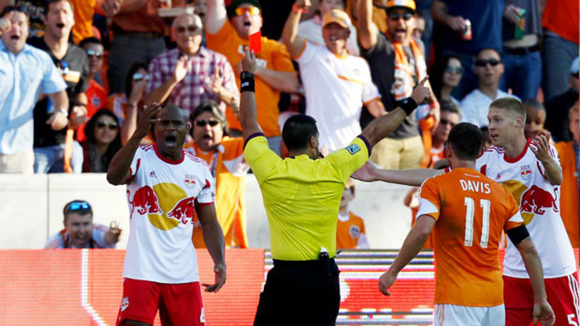New York Red Bulls' Jamison Olave reacts to red card after tackle on Omar Cummings.