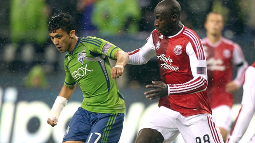 Seattle's Fredy Montero (left) receives a pass with Portland's Mamadou Danso on him.