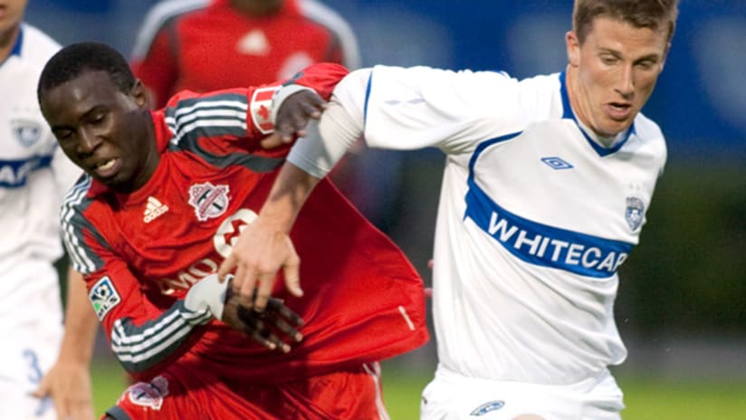 Toronto FC’s Gabe Gala (left) and Whitecaps FC’s Wes Knight vie for the ball.