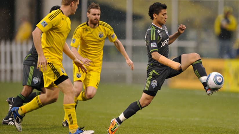 Fredy Montero of the Seattle Sounders breaks away from the Columbus Crew defense on Saturday night at Crew Sadium.