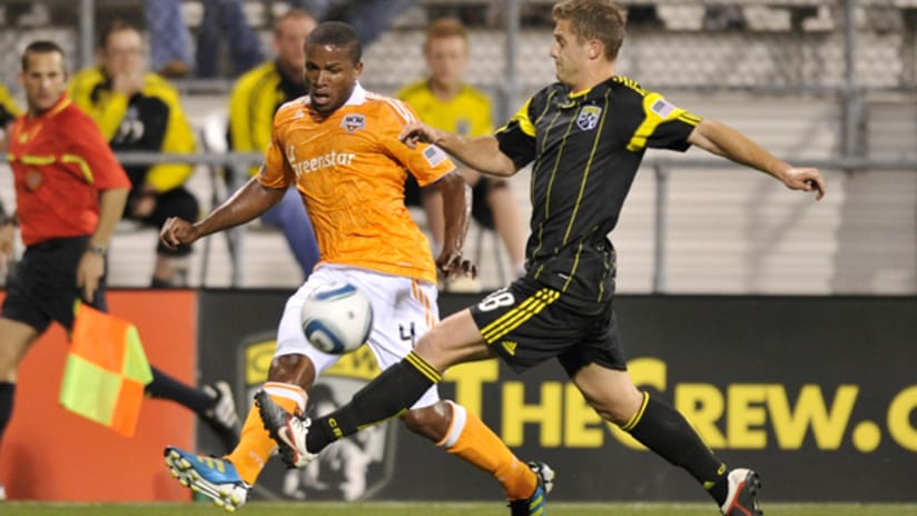 Jermaine Taylor crosses in front of Robbie Rogers