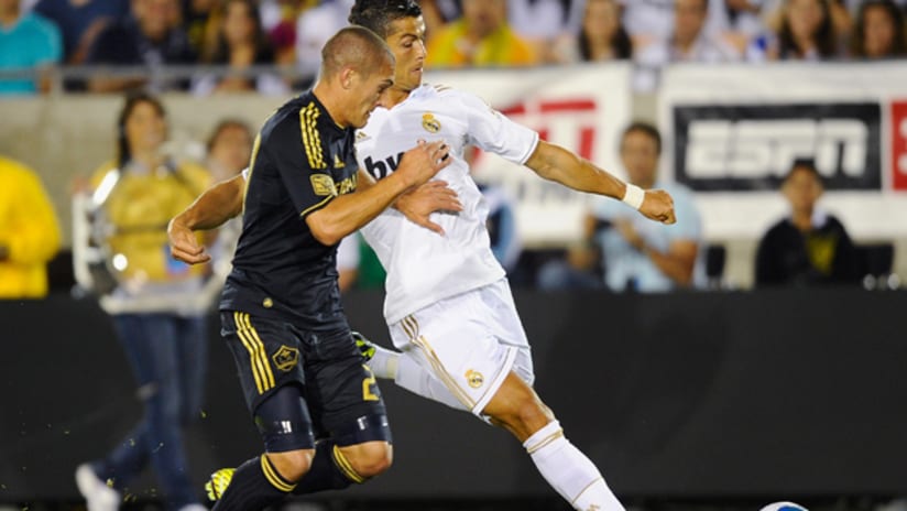 Cristiano Ronaldo controls against Bryan Jordan of LA