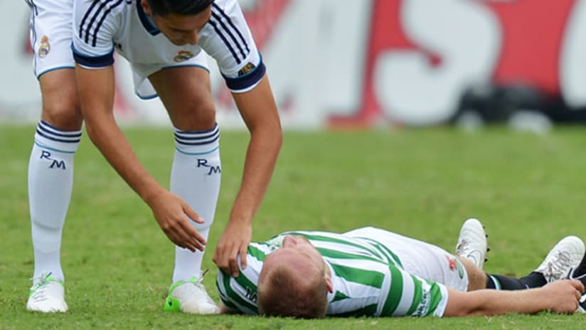 WFC: Real Madrid's Nuri Sahin checks on Celtic's Dylan McGeough after collision.