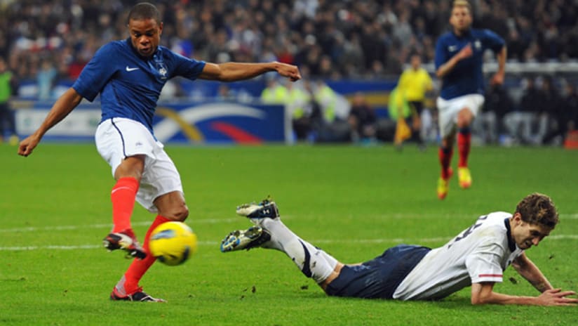 France's  Loic Remy fires the game-winning goal as US defender Clarence Goodson looks on.