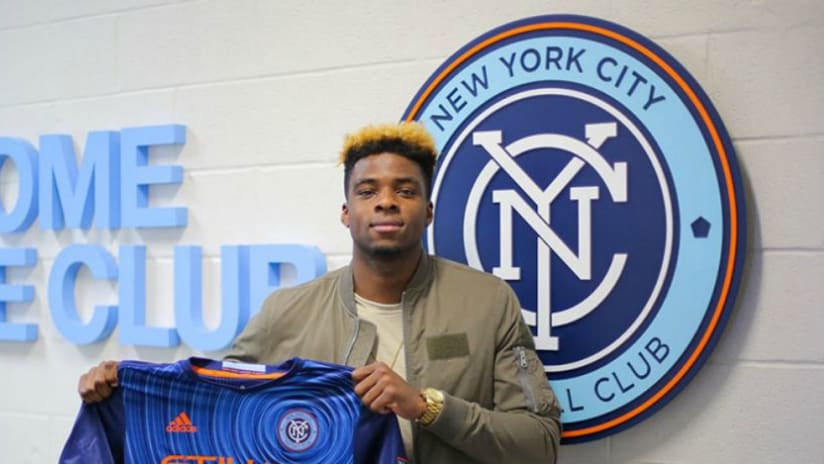 Sean Okoli -- NYCFC -- holding jersey at signing