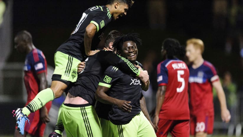 Happy Seattle Sounders forward Obafemi Martins gives a piggy back ride to Kenny Cooper and DeAndre Yedlin