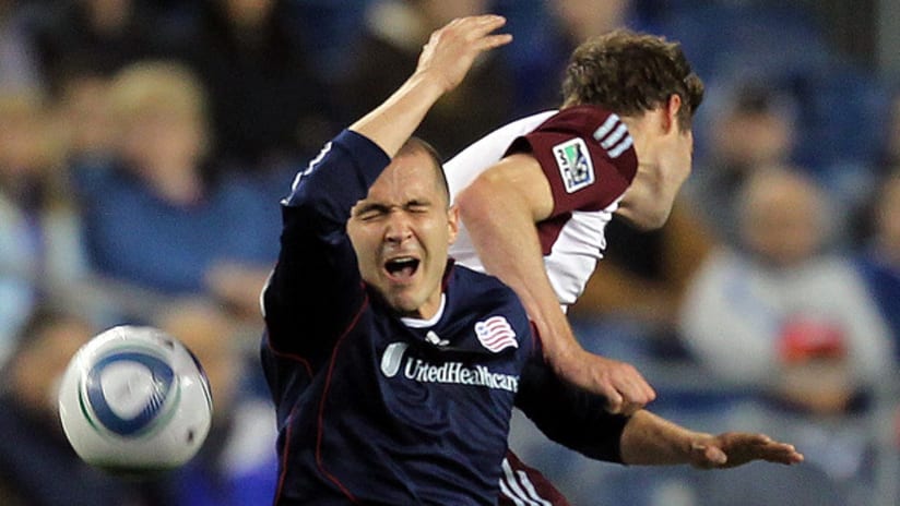 Rajko Lekic of the New England Revolution reacts to an elbow from Drew Moor of the Colorado Rapids.