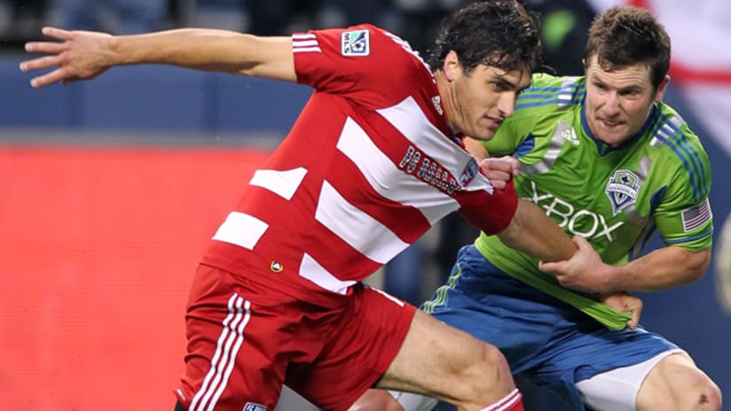 FCD's George John fends off Sounders' Mike Fucito.