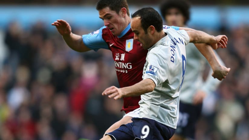 Everton loan item Landon Donovan takes on an Aston Villa defender