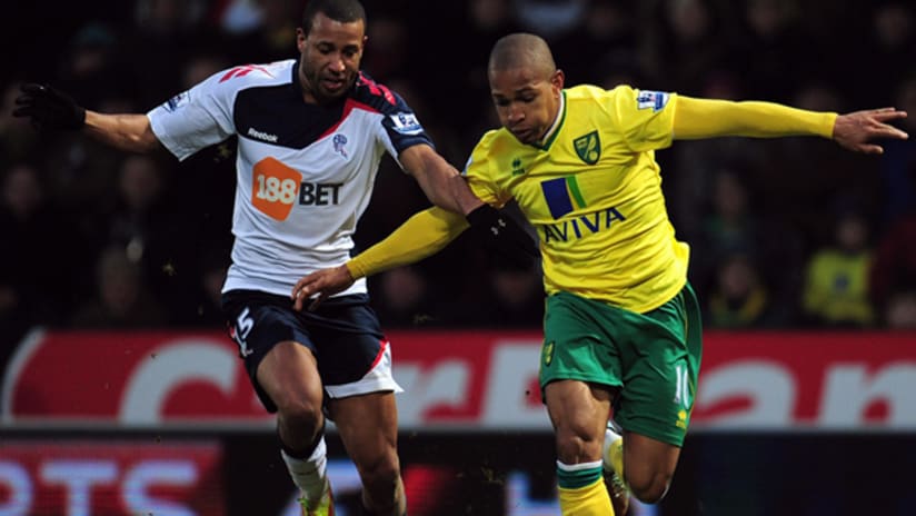 Norwich City's Simeon Jackson battles with Bolton's Tyrone Mears during an EPL match.