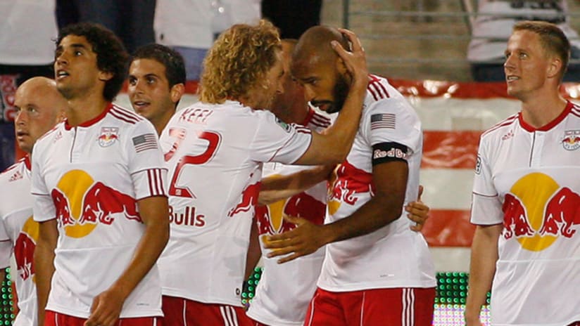 New York's Thierry Henry (center) is congratlated after scoring Saturday night against the New England Revolution.
