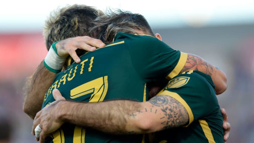 Portland Timbers attackers Maximiliano Urruti and Gaston Fernandez hug