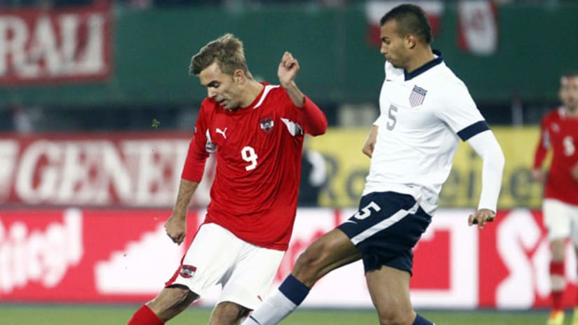 Austria's Lukas Hinterseer (L) and John Brooks of the USMNT fight for the ball