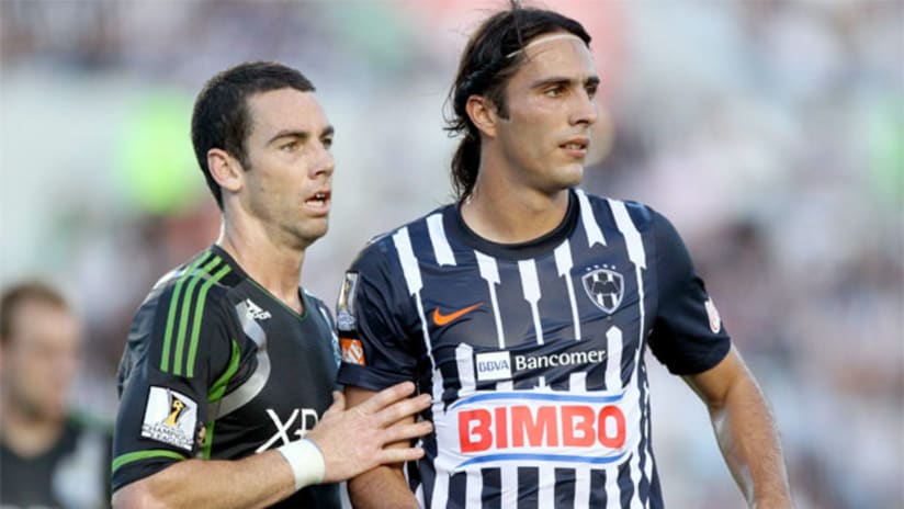 Zach Scott and Monterrey's Aldo de Nigris during CONCACAF Champions League action